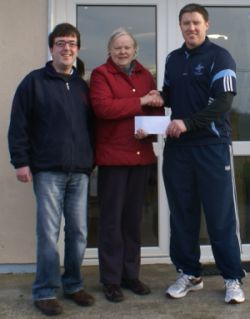 Michel Briody, Chairman of St Brigids GFC presenting Tess Brady with her winning blotto cheque of 3,800 in January 2011. Also in picture is ticket seller Eamonn Tuite Junior